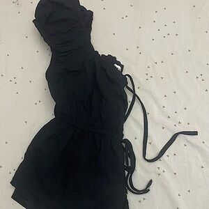 Black Square-necked babydoll top. Ruffle sleeves. Buttons and ribbons.